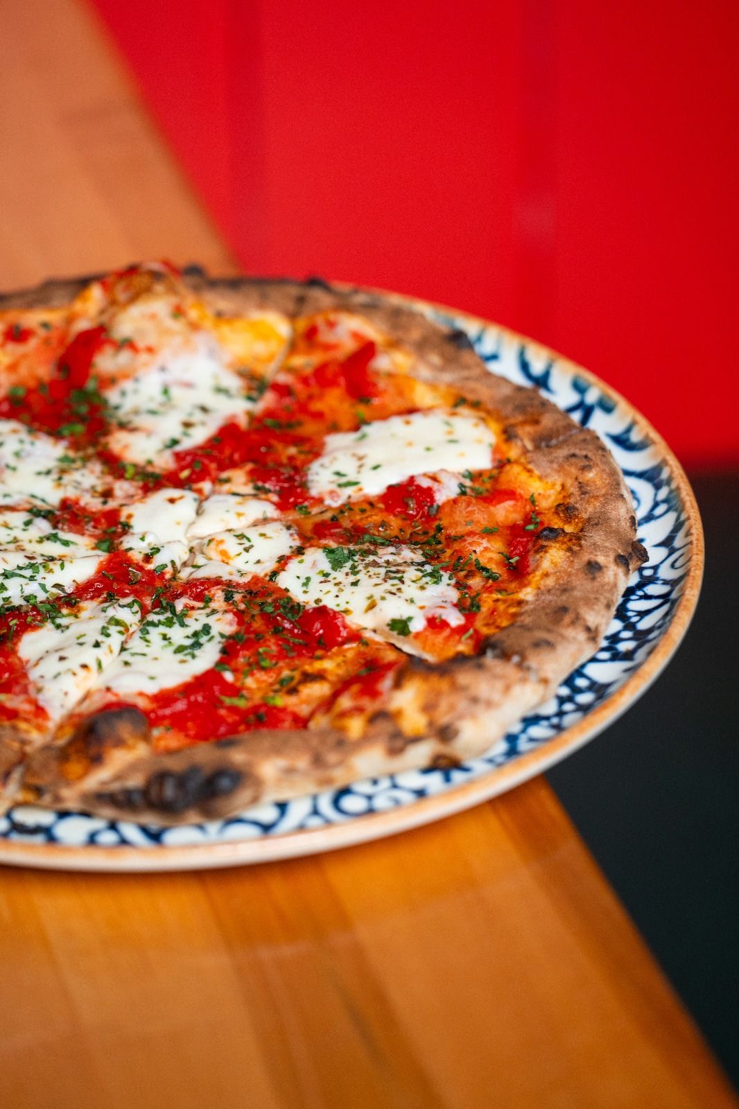 Wood-fired pizza with tomato, fresh mozzarella and parsley (opens Rosolini on Instagram)